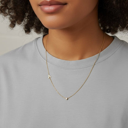 Lotus Diamond 14k gold necklace with single letter A charm and bezel-set diamond.