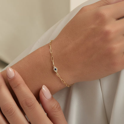 Lotus Diamond 14K gold paperclip bracelet with diamond and sapphire evil eye charm.