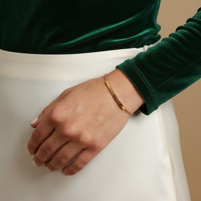 Lotus Diamond gold bar bracelet with engraved text on a woman's wrist, made from recycled gold.