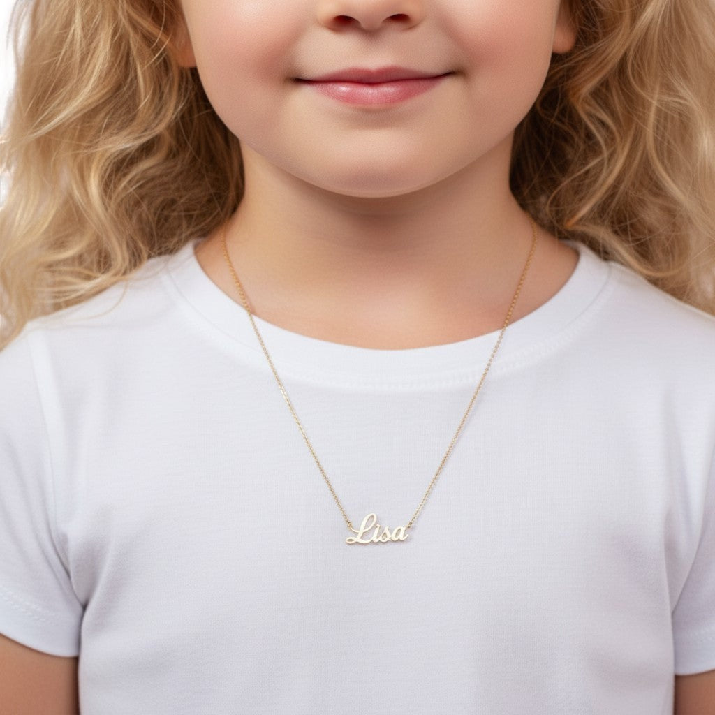 Lotus Diamond 14k gold cursive custom name necklace for kids, shown on a young girl wearing a white t-shirt.