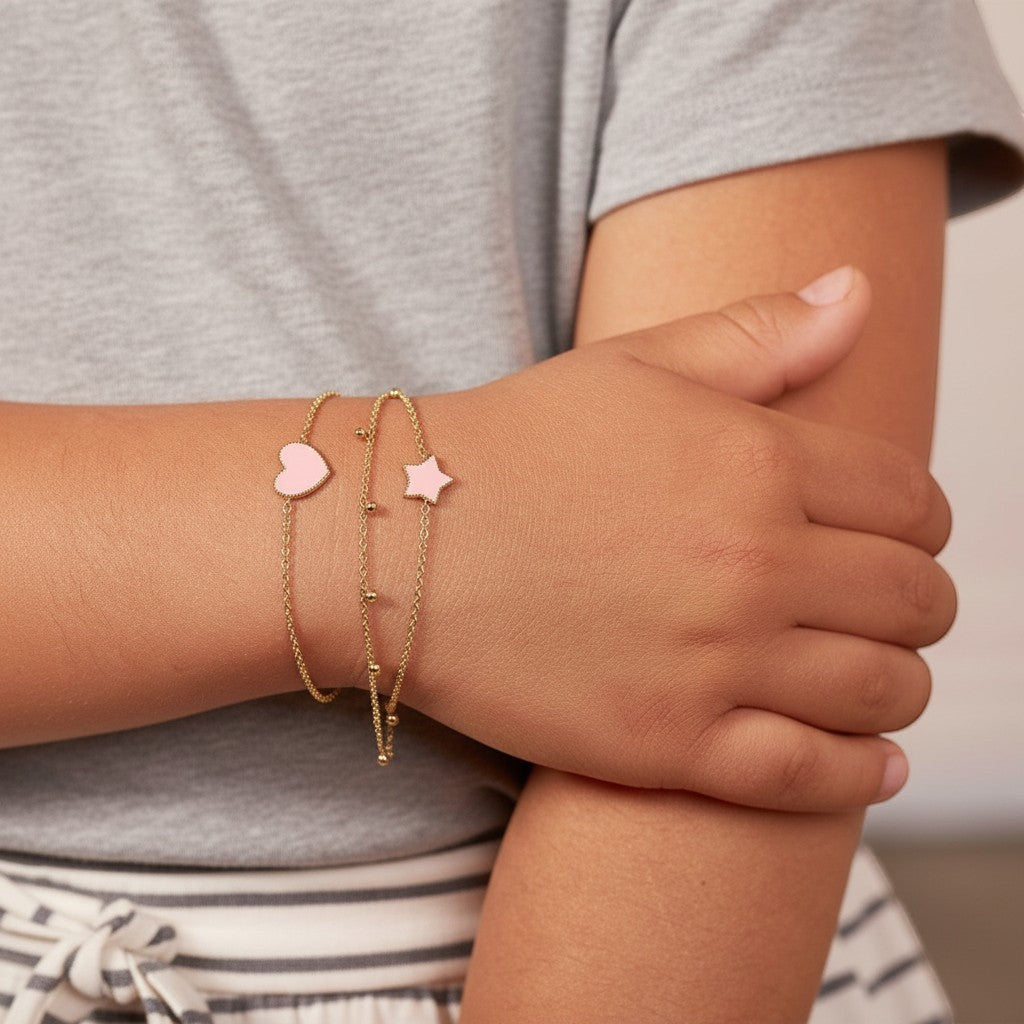 Lotus Diamond kids dainty gold bracelet with pink heart and star charms, made from recycled gold.